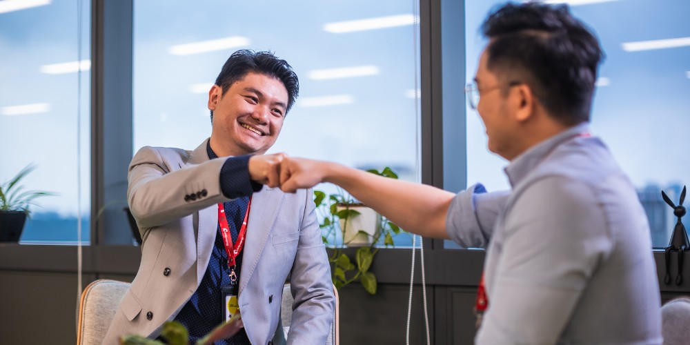 QubeApps Mid-Year Review Peer Support Fist Bump