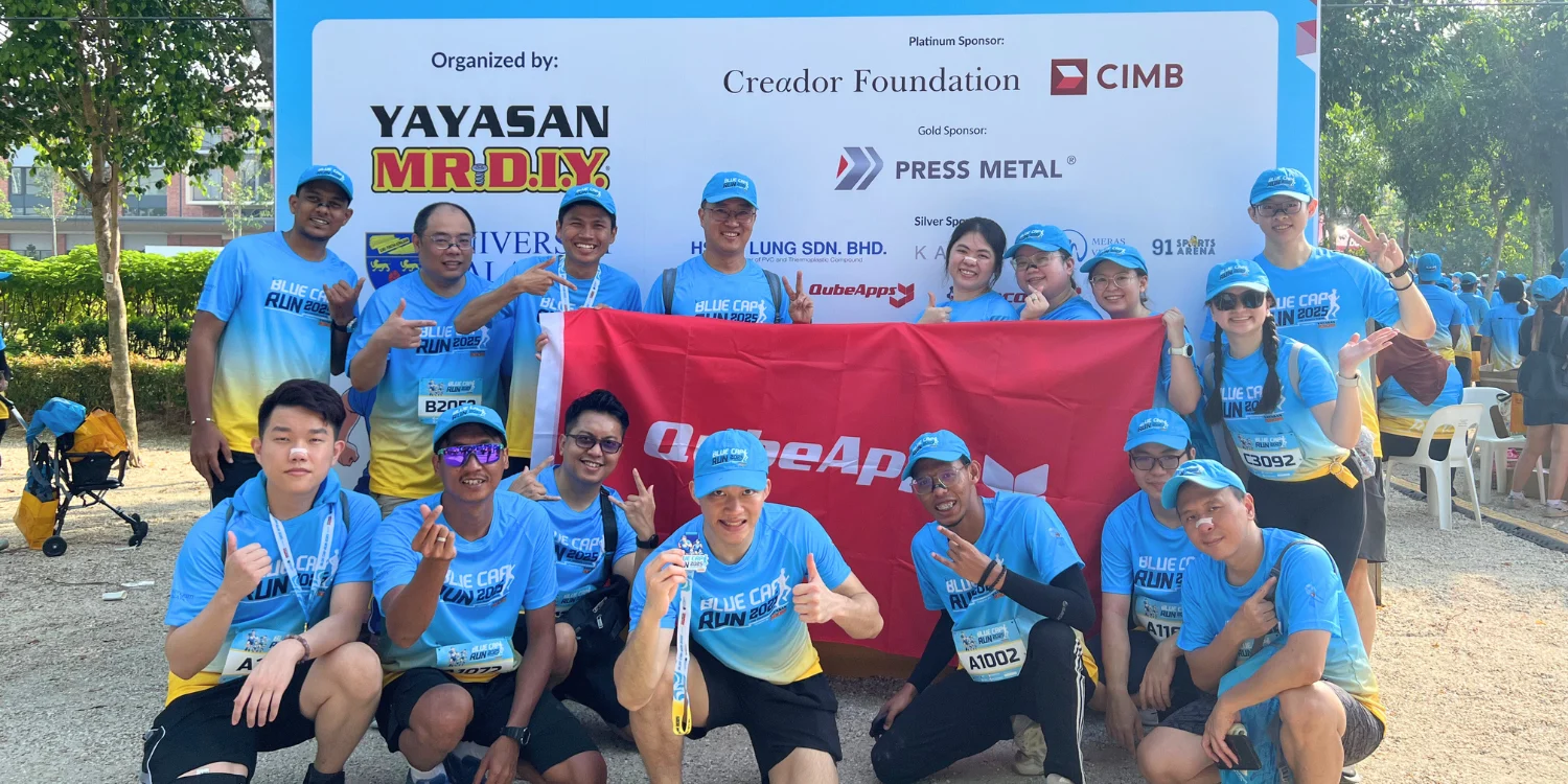 Qubers posing at the Blue Cap Run 2025 event, showing company spirit and support for prostate cancer awareness