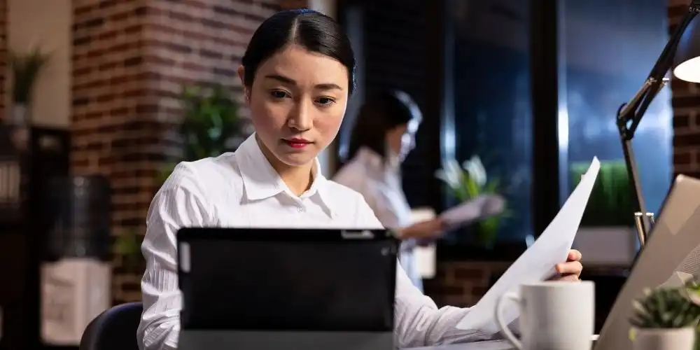 Employee dealing with daily IT disruptions and operational stress in a modern SME office