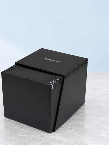 Three-quarter close-up of a black POSBANK A6 receipt printer, showing its lid, paper path and controls.